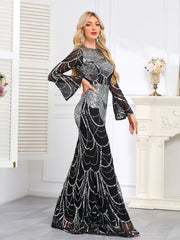 Elaborately Crafted Black And Silver Sequined Mermaid Gown With Bell Sleeves.