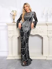 Elaborately Crafted Black And Silver Sequined Mermaid Gown With Bell Sleeves.