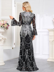 Elaborately Crafted Black And Silver Sequined Mermaid Gown With Bell Sleeves.