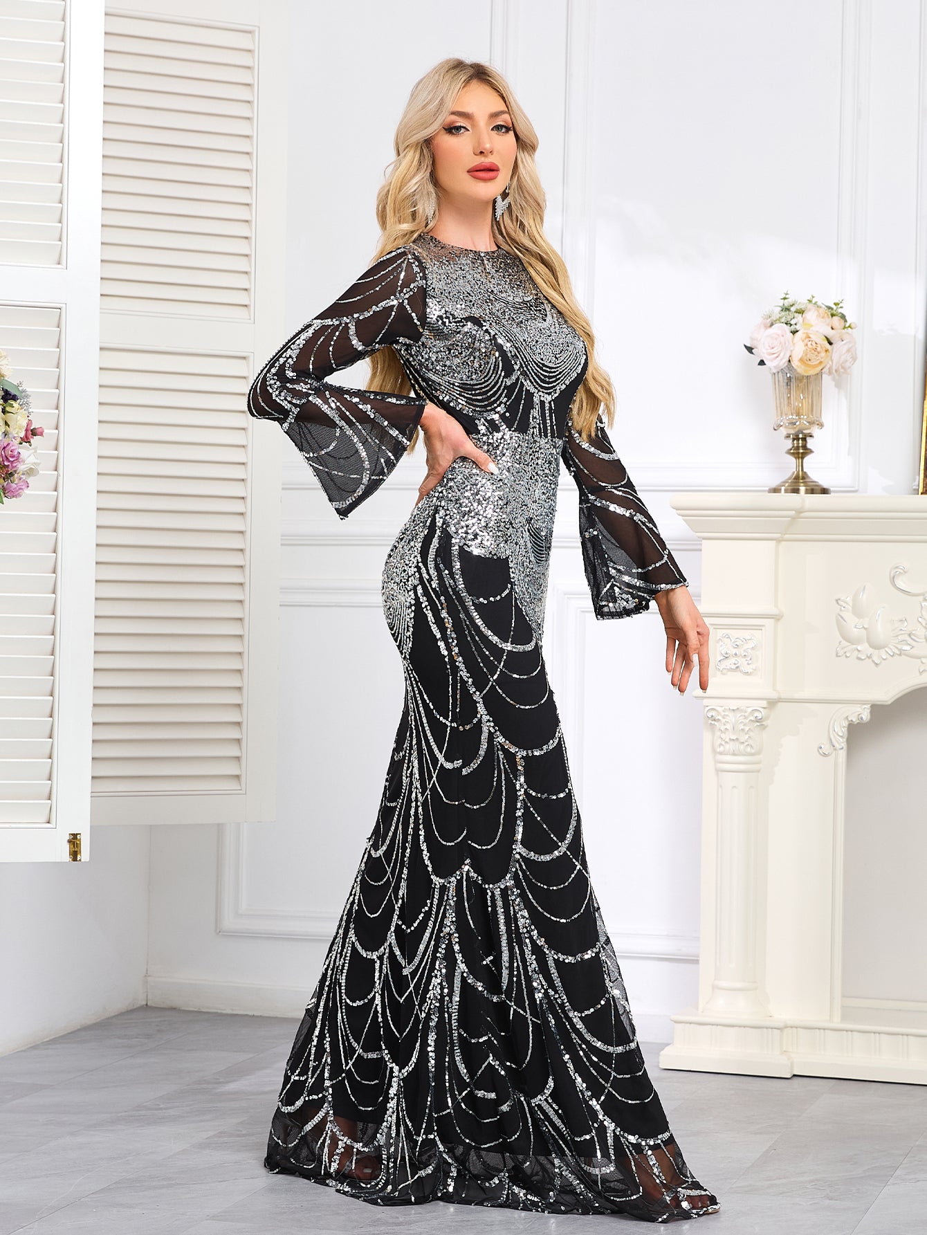 Elaborately Crafted Black And Silver Sequined Mermaid Gown With Bell Sleeves.