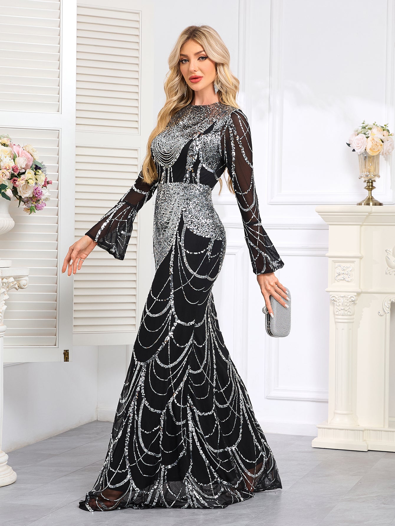 Elaborately Crafted Black And Silver Sequined Mermaid Gown With Bell Sleeves.