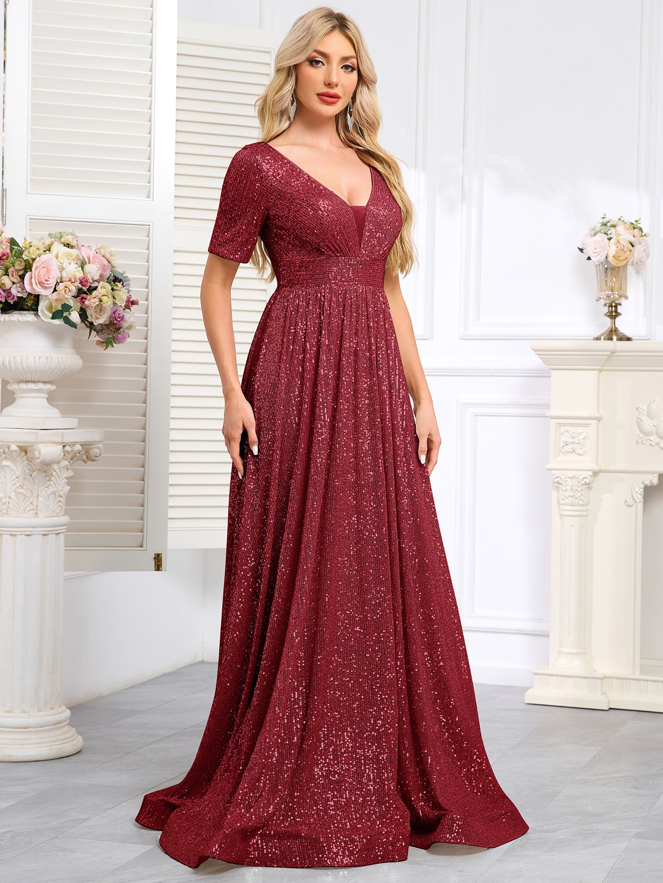 Royal Blue Sequined Short-Sleeve Gown With a Deep V-Neck and a Full, Flared Skirt.